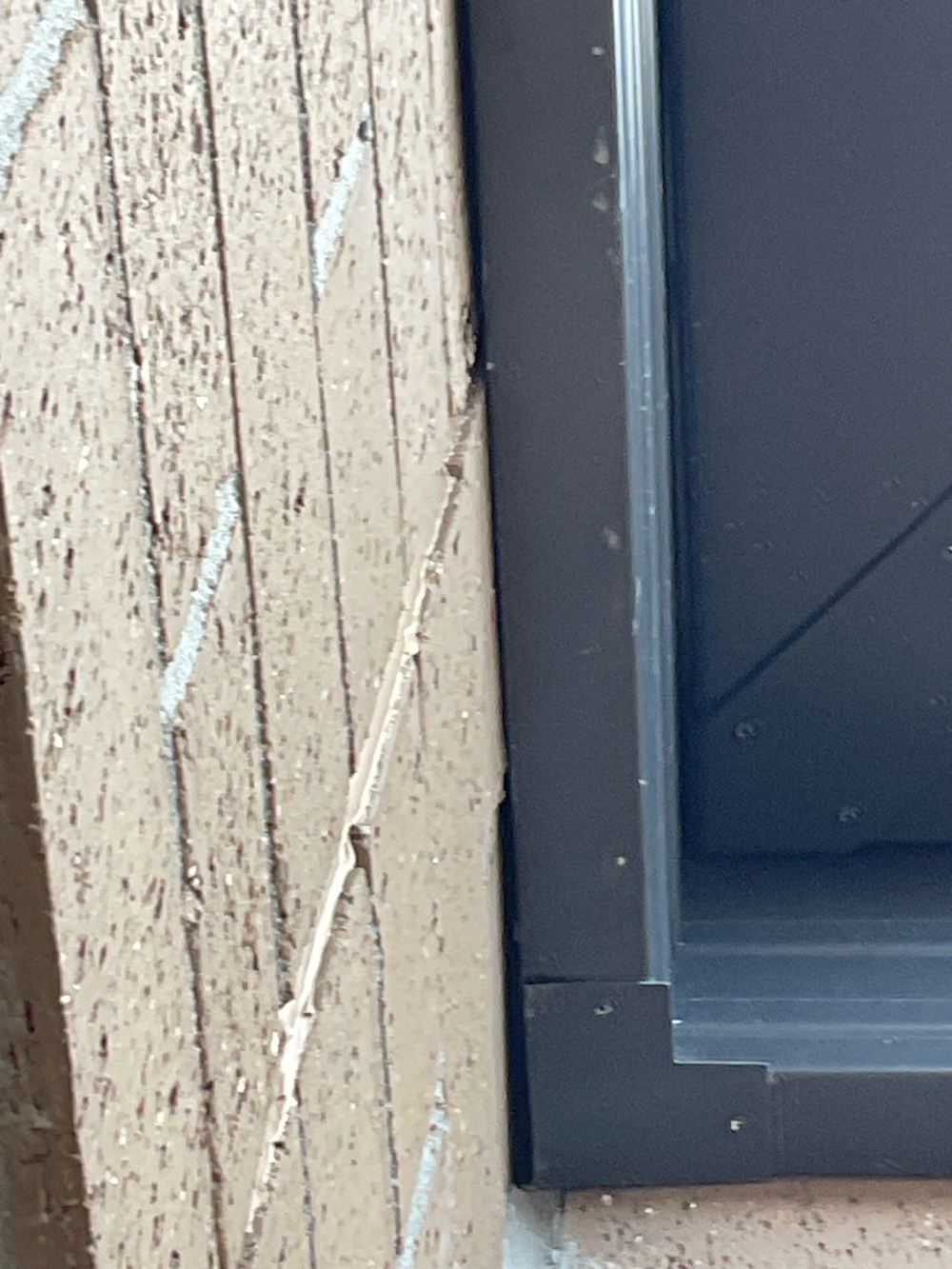 Gap between brickwork and metal fascia, recorded on a fixing stage inspection in Fraser Rise