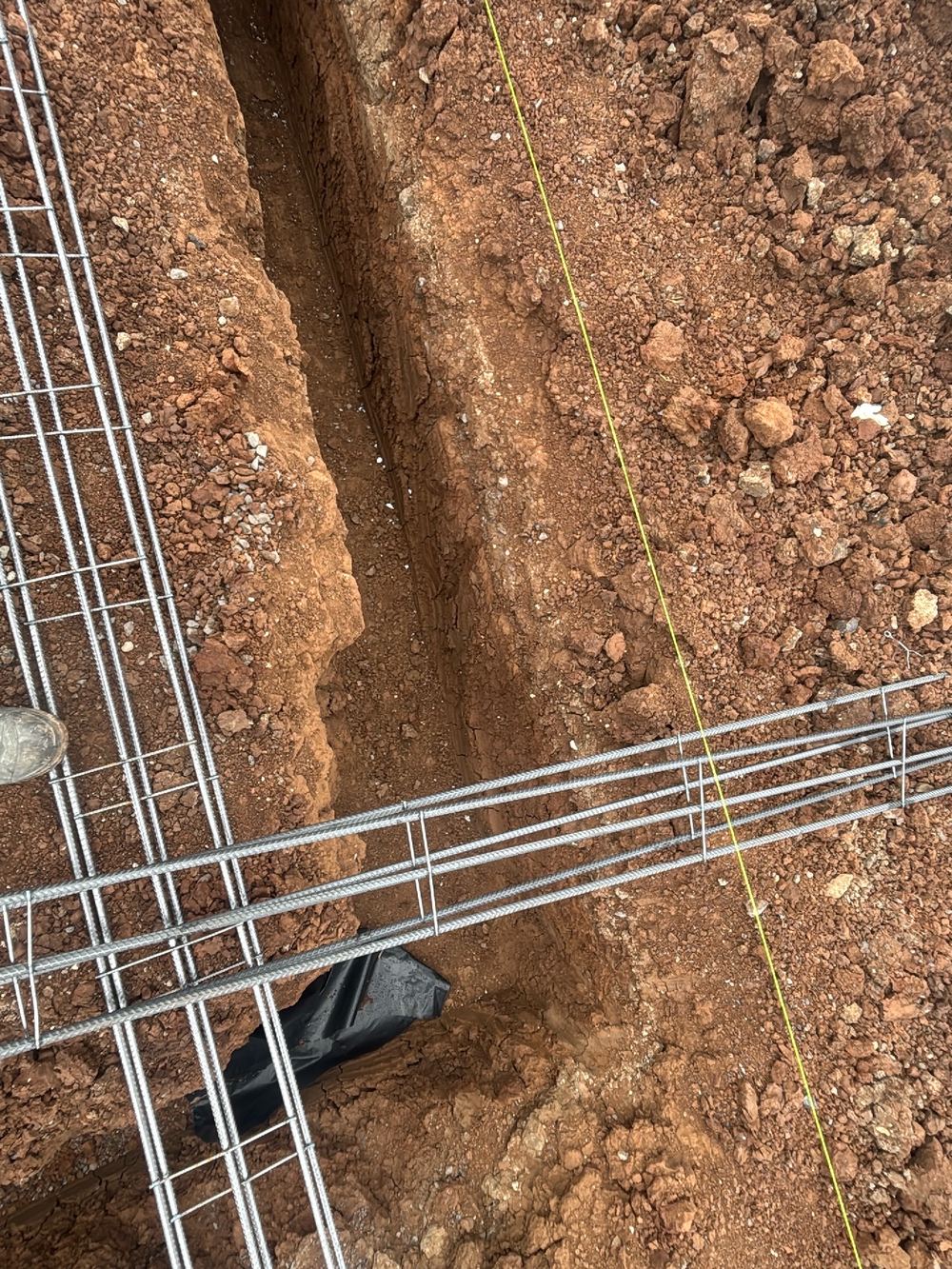 Strip footing top trench mesh missed, recorded on a slab pre-pour inspection in Fraser Rise